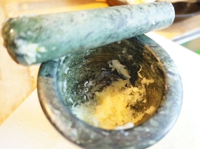I pound the ginger and garlic together in a mortar--crushing them but stopping short of making a paste. There's no reason you shouldn't make a paste if you don't have a mortar and pestle, but please do not use commercial ginger and/or garlic pastes.