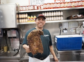 This genial gent was manning the counter; when I asked him if I could take a picture with him in it he gesticulated no, went over to the cooler and got out a giant smoked brisket and said, "Now you take a picture!" And I did.